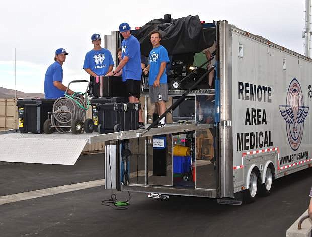Western Nevada College baseball team members help unload the Remote Area Medical truck at Carson High School Thursday afternoon during set-up for the free medical clinic being held today. The clinic runs from 6am Friday until 2pm on Sunday.