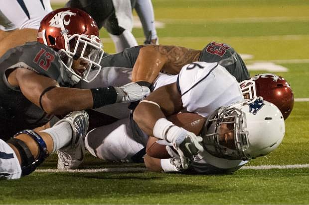 Nevada&#039;s Don Jackson (6) scores after getting past Washington State&#039;s Darryl Monroe (13) and Tana Pritchard during the first half of an NCAA college football game Friday, Sept. 5, 2014 in Reno, Nev. (AP Photo/Kevin Clifford)