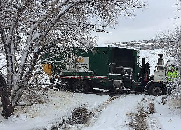 A Waste Management truck is stuck in the snow during the snowstorms of last week.
