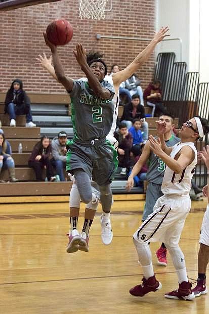Elijah Jackson (2) races Sparks players to the basket during Tuesday&#039;s game at Sparks High School.