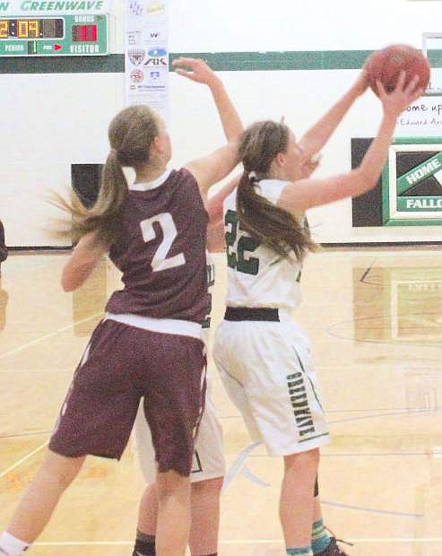 Caitlyn Welch (22) of Fallon keeps the ball away from Alexis Elquist.
