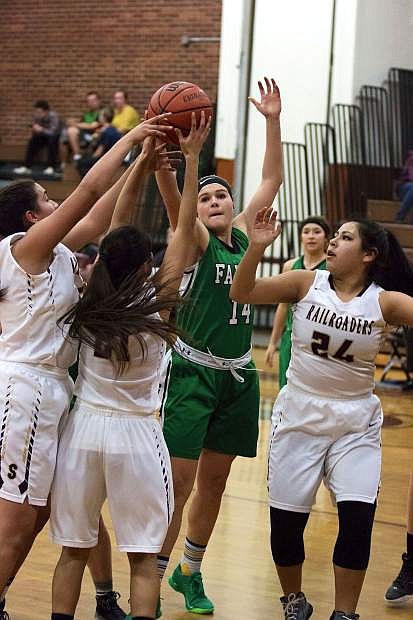 Chandler McAlexander (14) shoots the basket as a gang of Sparks players try to block her.