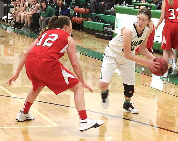 Caitlyn Welch looks for an opening past Truckee&#039;s Marlena Montano (12) during the Lady Wave&#039;s Friday home game.