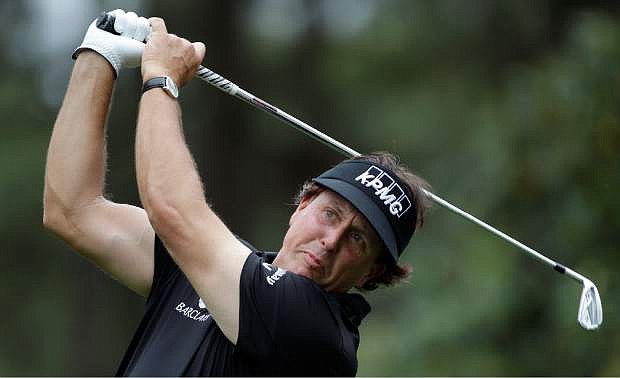 Phil Mickelson watches his tee shot travel to the sixth green during the pro-am of the Wells Fargo Championship golf tournament at Quail Hollow Club in Charlotte, N.C., Wednesday, April 30, 2014. (AP Photo/Bob Leverone)