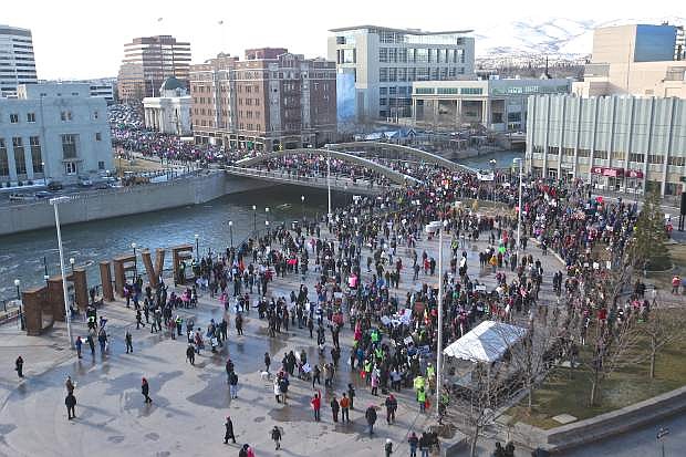 Marchers make their way across the Virginia St. bridge and into City Plaza in downtown Reno Saturday morning.