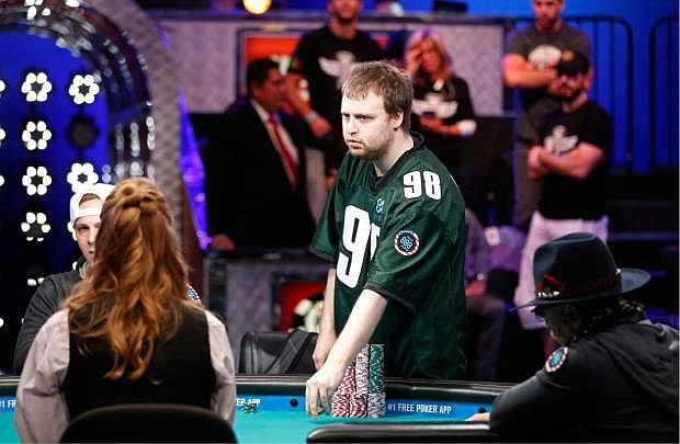 Joseph McKeehen stands at his seat at the World Series of Poker Sunday, Nov. 8, 2015, in Las Vegas. Sunday night was the first of three days of poker-playing before crowning a new champion and awarding more than $7 million to the winner. (AP Photo/John Locher)