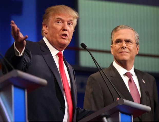 FILE - In this Aug. 6, 2015, file photo, Republican presidential candidates Donald Trump and Jeb Bush participate in the first Republican presidential debate at the Quicken Loans Arena in Cleveland. Presidential debates were big draws and big business for the networks that presented them in 2015 _ at least, when Donald Trump was involved. The first Republican debate was watched by 24 million viewers, the highest-rated broadcast in Fox News Channel&#039;s history.  (AP Photo/Andrew Harnik, File)