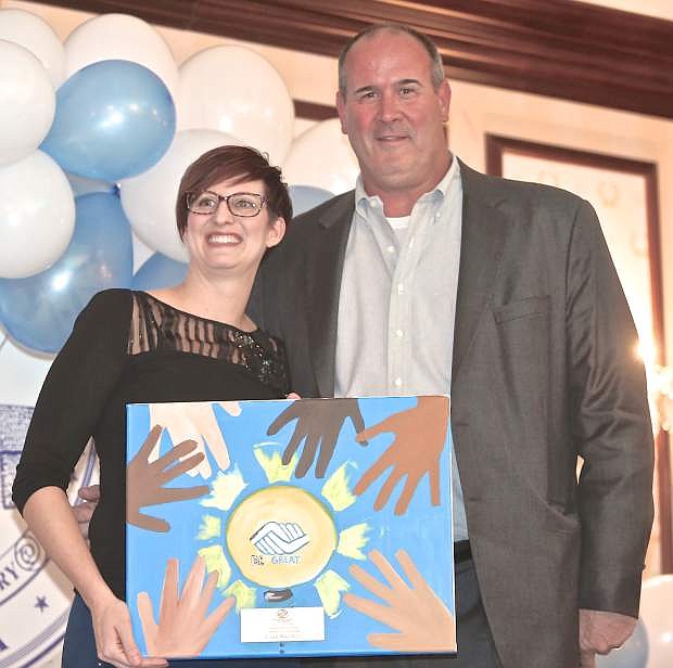 BGCWN Executive Director Katie Leao presents Oakland Raiders offensive line coach Mike Tice with the Carson Valley Comunity Recognition Award Thursday night at the Governor&#039;s Mansion.