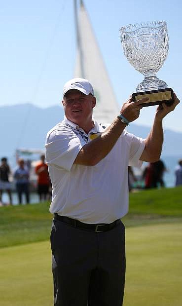Billy Joe Tolliver hoists the American Century Championship cup on Sunday at Edgewood Tahoe Golf Course. Tolliver went through three rounds of playoffs on 18 against Mark Rypien for the win.