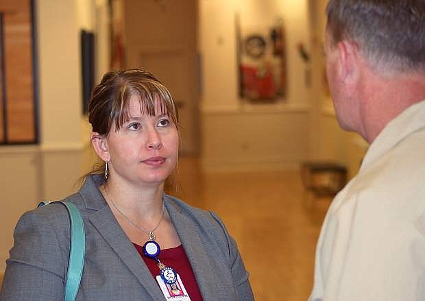 Dr. Lisa Rausmussen talks to a well-wisher at a reception hosted by the Chamber of Commerce.