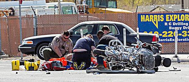 Churchill County Sheriff deputies and paramedics from Banner Churchill Community Hospital tend to an injured motorcyclist who was involved in a Friday morning accident at Sheckler Cut Offf and U.S. Highway 50.