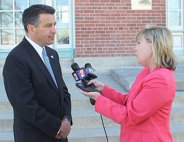 Gov. Brian Sandoval talks to reporters Friday monring in Fallon about Sen. Harry Reid not running for re-election and his own plans.