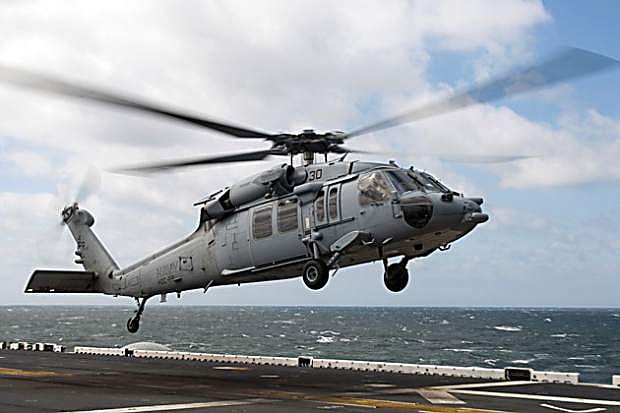 An MH-60S Sea Hawk helicopter takes off from the flight deck of the amphibious assault ship USS Kearsarge (LHD 3). A helicopter similar to this one crashed in Dixie Valley on Tuesday.