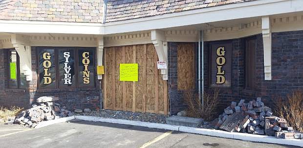 The wall of Northern Nevada Coin is boarded up after a woman drove her car through it Dec. 18.