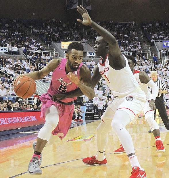 The Wolf Pack&#039;s D.J. Fenner attempts to get around New Mexico&#039;s Aher Uguak.