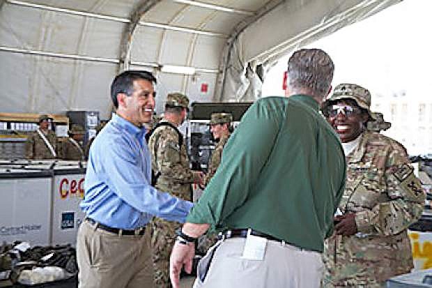 Governors Brian Sandoval, left, and Jay Nixon, Missouri, meet with a soldier in Afghanistan this weekend.