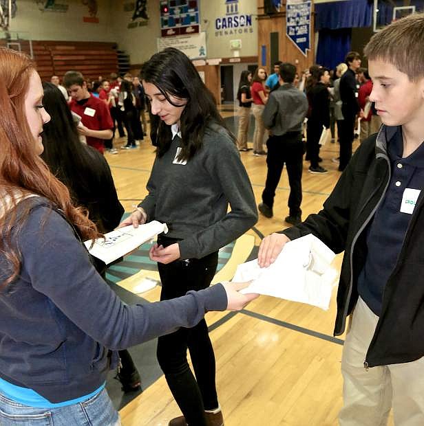 Carson High junior Alexa Haight hands out a CTE goodie bag to Eagle Valley 8th grader Anthony Meyer Wednesday.