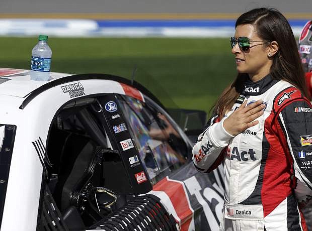 Danica Patrick stands by her car during the national anthem before the NASCAR Clash auto race at Daytona International Speedway, Sunday, Feb. 19, 2017, in Daytona Beach, Fla. (AP Photo/John Raoux)