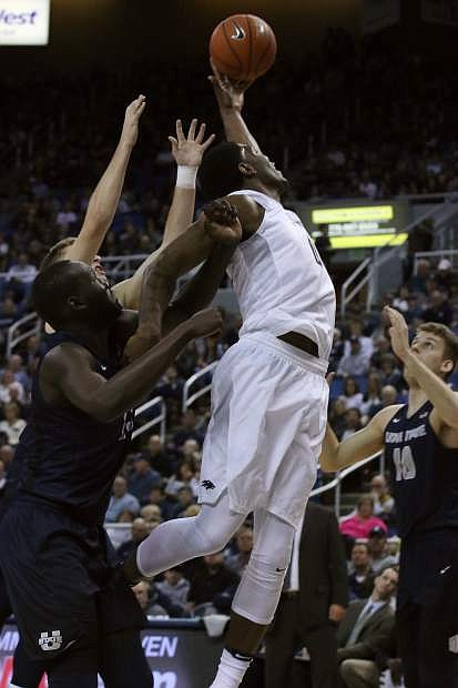 Nevada&#039;s Cameron Oliver jumps for a rebound against the Aggies on Saturday at Lawlor Events Center.