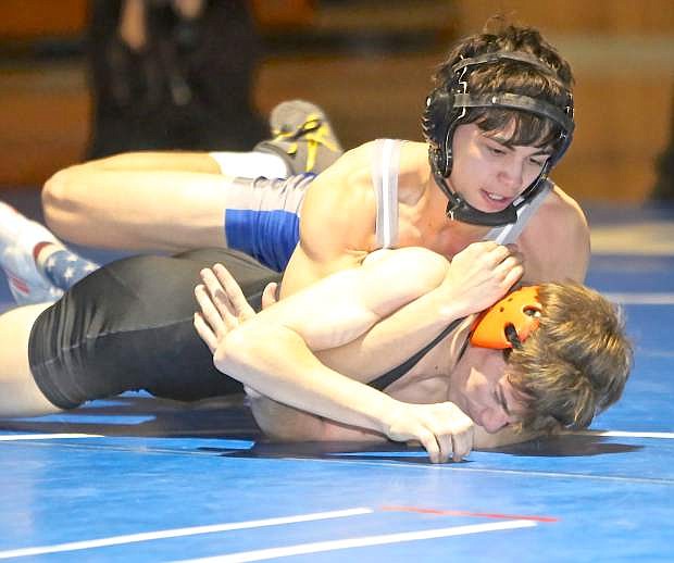 Carson&#039;s Brandon Basa on his way to defeating Douglas standout Kindel Isham in a 120 pound match Wednesday night at CHS.