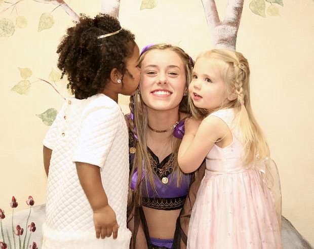 &quot;A Magical Moment&quot; is the theme for this year&#039;s Father / Daughter Dance at Carson High School on March 31. Abby &quot;Princess Jasmine&quot; Golik, who will be attending the dance gets a kiss and hug from 3-year-olds Victoria Quintana and Reagan Gustavson.