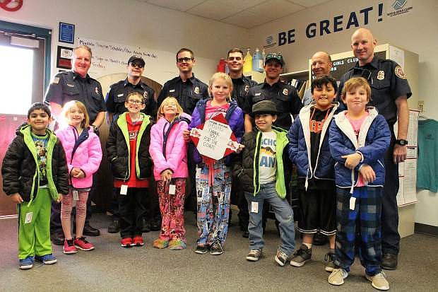 Members of the East Fork Professional Firefighters deliver brand new, American union made warm winter coats to members of the Boys &amp; Girls Clubs of Western Nevada Carson Valley Clubhouse.