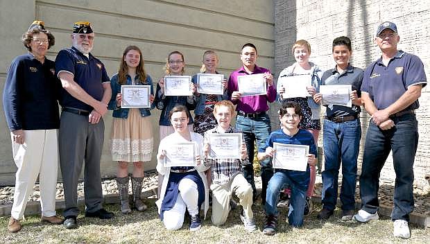 Winners that attended the awards luncheon of the Fleet Reserve Association&#039;s essay contest pose with FRA leaders Brenda and Verne Horton (left) and Rick Athenour (right) Saturday in Carson City.