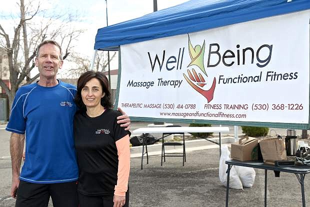 Well Being Massage and Functional Fitness owners Brad and Alina Paula wait for 5k runners to finish during the Fitness For Life grand opening Saturday morning in Carson City.