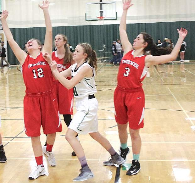 Kaitlyn Hunter, center, pushes between Truckee&#039;s Marlena Montono, left, and Isabella Abarno during a Lady Wave home game earlier this season.