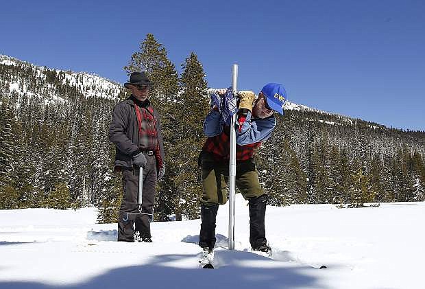 Frank Gehrke, chief of the California Cooperative Snow Surveys Program for the Department of Water Resources, plunges the survey tube into the snowpack as he conducts the third manual snow survey of the season at Phillips Station on March 1 near Echo Summit.