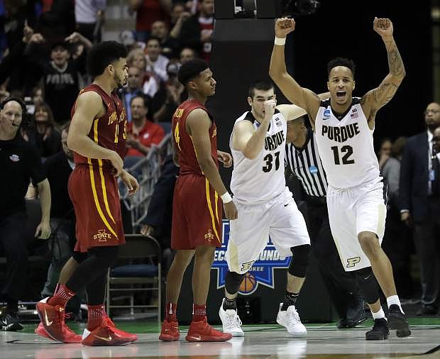 Purdue&#039;s Vince Edwards (12) and Dakota Mathias (31) celebrate after defeating Iowa State 80-76 on Saturday in Milwaukee.