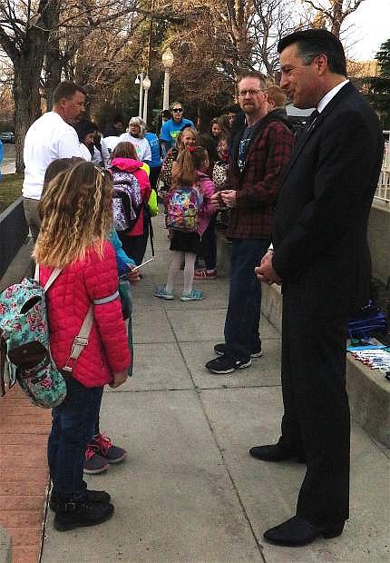 Gov. Brian Sandoval talks with two students from Bordewich Bray Elementary school Wednesday morning.