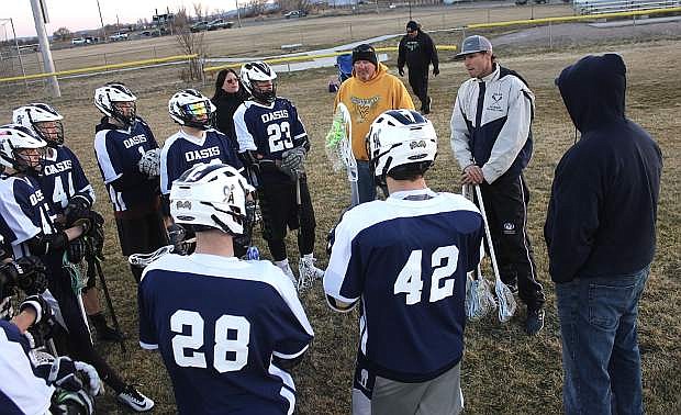 Lorne Smith, in white, gets ready to guest coach the Oasis Academy boys&#039; lacrosse team.