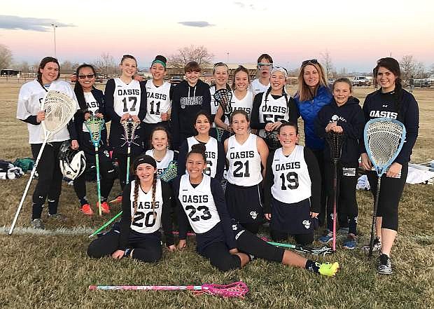 The Oasis Academny girls&#039; lacrosse team pose for a picture after their first game of the season.