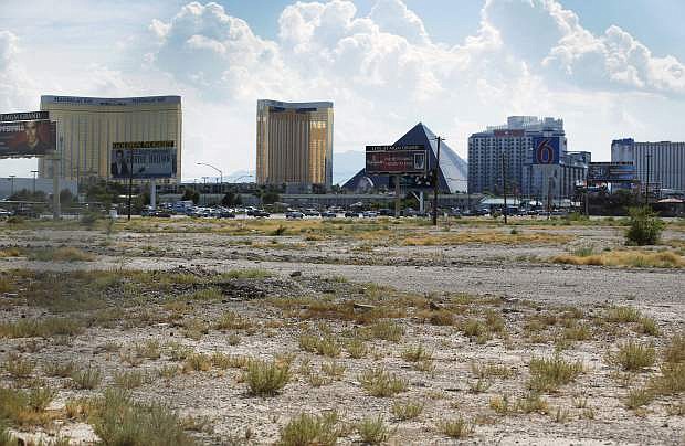 FILE - In this July 1, 2016, file photo, a vacant lot that is the site of a proposed football stadium sits near McCarran International Airport in Las Vegas. The board overseeing the proposed Las Vegas NFL stadium was set to meet Thursday, March 9, 2017, for the first time since the Oakland Raiders told the league that they have found a new partner to finance the facility. The meeting of the stadium authority board comes the same week the team presented to the NFL the new proposal with financing backed by Bank of America. (AP Photo/John Locher, File)