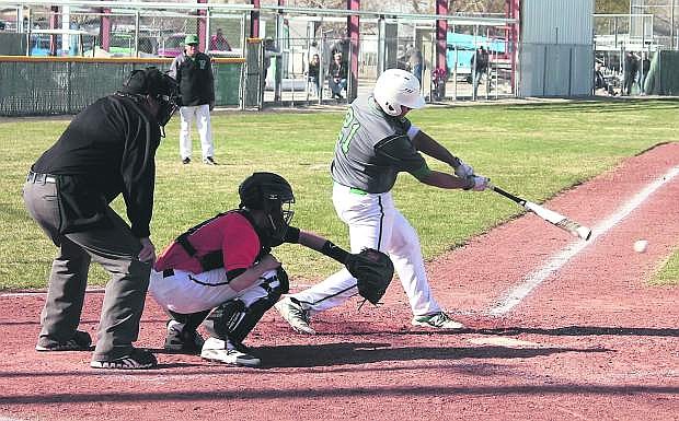 Edgar Alvarado, 21, swings on a pitch during the Greenwave&#039;s home game against Fernley.