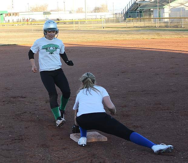 Alexis Jarrett, left, gets tagged by Stacy Kalt during a Lady Wave practice session.