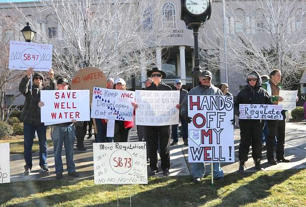 Demonstrators gather in front of the Legislature to protest proposed bills that will reduce and restrict private water wells.