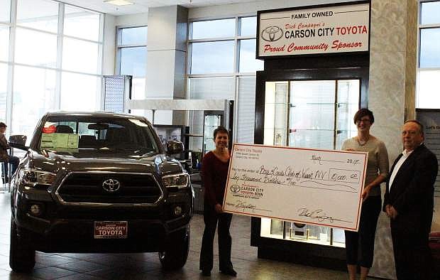 Andie Wilson, president of the board of directors, and Katie Leao, chief professional officer for the Boys &amp; Girls Clubs of Western Nevada, receive the Carson City Toyota Scion Community Challenge matching funds in the amount of $10,000 from Dana Whaley, general manager for Carson City Toyota Scion.