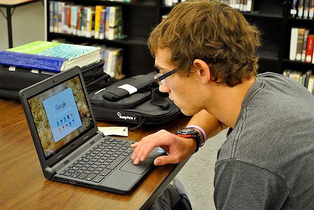 Churchill County High School junior Thomas James starts work on his Google Chromebook during a study hall period.
