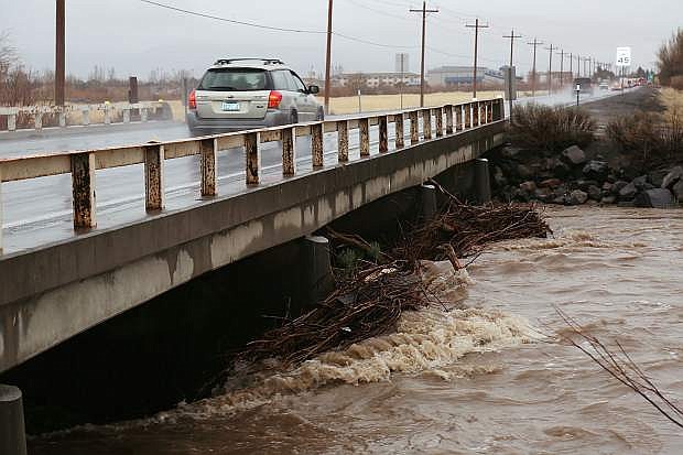 Debris piles up against the bridge on HIghway 88 south of Minden in February after a state of emergency was declared for Douglas after another bout of heavy rain and flooding.