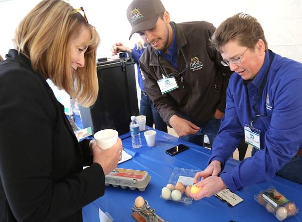 Participating in the Agriculture Day at the Legislature, Sheryl Hunnnewell, with the Nevada Department of Agriculture demonstrates the use of an egg candler, which checks the freshness and the internal quality of an egg.