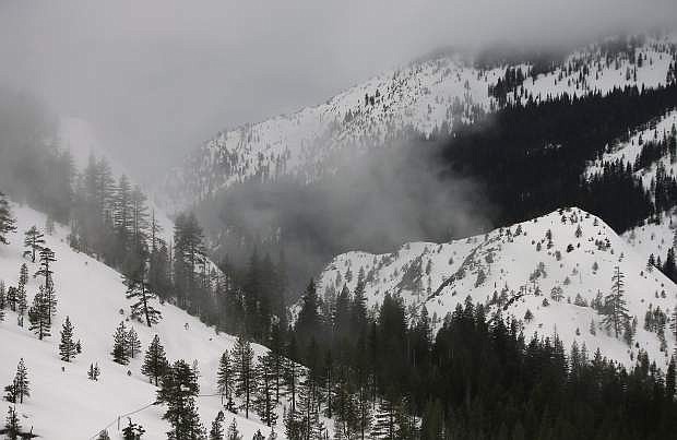 FILE - In this Thursday, Feb. 2, 2017 file photo, fog and mist shroud the Sierra Nevada, near Echo Summit, Calif. The National Weather Service says this is now the wettest winter on record in the Northern California mountains. Weather Service officials say an index of precipitation at eight stations in the northern Sierra Nevada surpassed the old record at about 4 a.m. Thursday, April 13, 2017, with just under 90 inches of rain and snow. The previous record of 88.5 inches was set in the winter of 1982-1983. (AP Photo/Rich Pedroncelli, File)