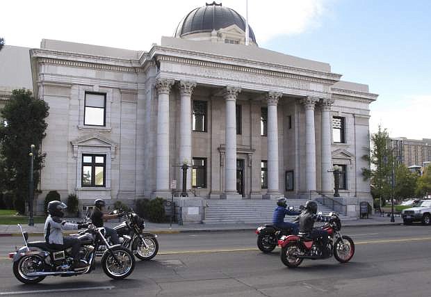 FILE - In this Sept. 23, 2016, file photo, motorcyclists drive pass in front of the Washoe County Courthouse downtown Reno, Nev. marking the fifth anniversary of a deadly shootout at a casino in neighboring Sparks between the Hells Angels and Vagos gang in 2011. Gary Rudnick, the star witness who helped convict the triggerman, Ernesto Gonzalez, who killed a high-ranking Hells Angels&#039; boss at a Nevada casino in 2011 said he was lying when he testified that the shooting was an assassination plot orchestrated by a rival motorcycle gang, according to documents obtained by The Associated Press. Gonzalez is scheduled to be tried again in August 2017 after his conviction was tossed on a technicality. (AP Photo/Scott Sonner, File)
