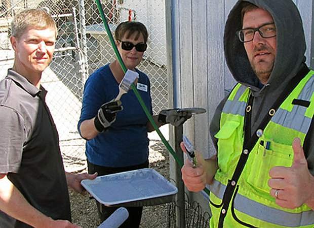 From left: Brent Farr of Farr West Engineering, Cheryl Couch, Community Programs Director for USDA Rural Development, and Yerington Public Works Director Jay Flakus paint the Yerington Animal Shelter as part of an Earth Day Service Project April 19 on Yerington.