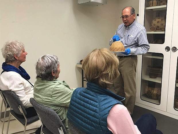 Anthropology tour guide Eugene Hattori explains the history behind a woven basket, dating back to at least the 1800s, at the Nevada State Museum Friday.