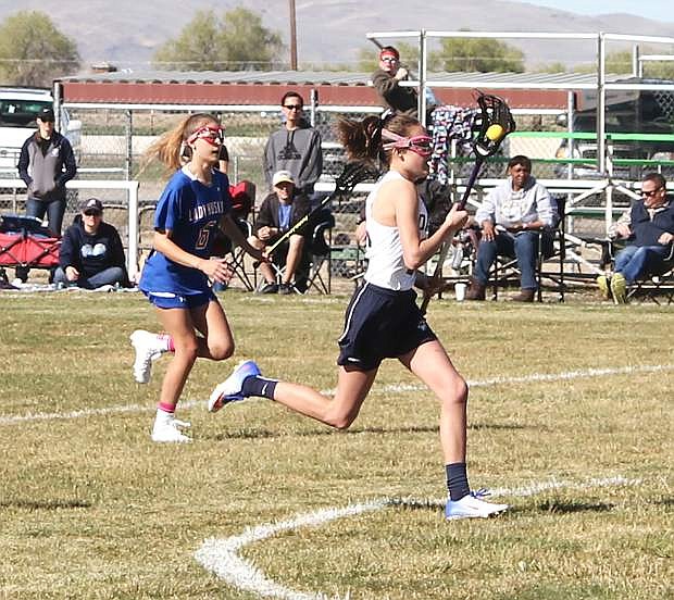 Sadie O&#039;Flaherty races the ball down the field to score a goal against the Reno Lady Huskies.