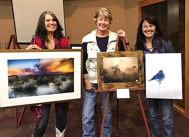 From left, Marie Nygren, Jennifer Manah and Sheree Jensen pose with their photographs that won top marks at renowned symposia Shooting the West, which took place in March in Winnemucca.