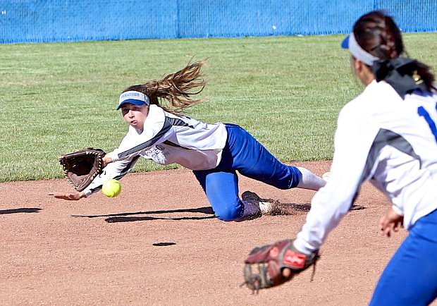 Carson shortstop Bella Kordonowy makes a diving stop Thursday against Reed.