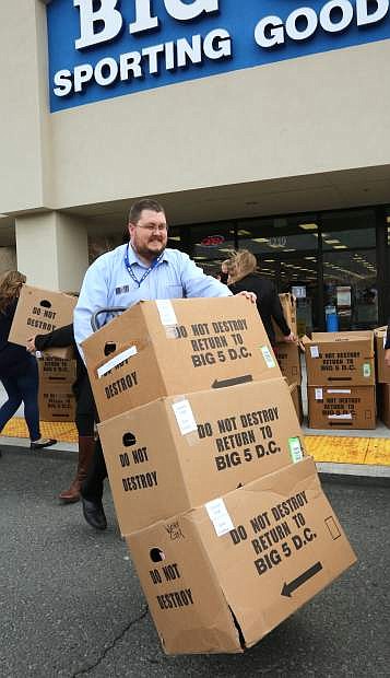 Big 5 Spoting Goods store manager Scott Norris loads boxes of shoes into a truck on Tuesday morning. More than 350 pairs of shoes will be provided to Carson City School District needy students in transition.